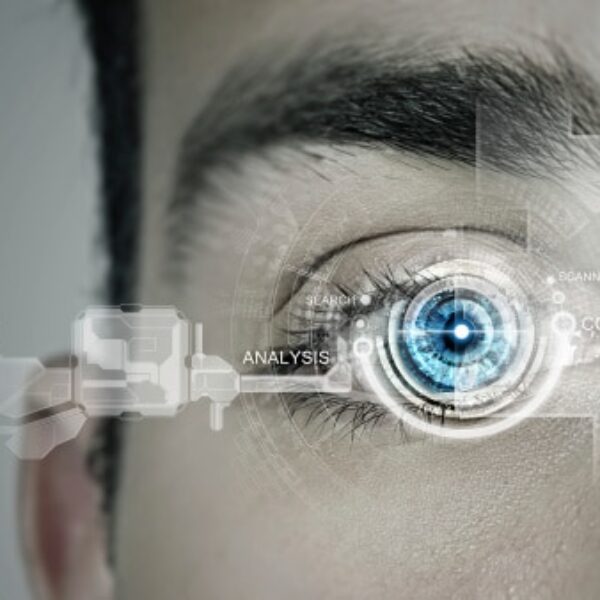 Close-up of a human eye with blue iris. Digital interface elements surround the eye, including the words