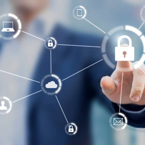 A person in a suit points to a digital lock icon on a transparent screen. Other icons, including a laptop, smartphone, cloud, user, and email, are connected by lines, representing a network of interconnected security elements.