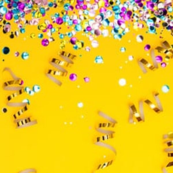 ribbons and confetti on a festive yellow background