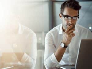 young businessman looks at his computer