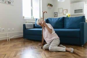 Senior Woman Suffering From Faint Lying on Floor After Falling Down at Home. Elderly Woman Fell on the Floor